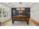 Bright dining room featuring a modern light fixture, large window, and ample seating at 143 Sallyport Ct, Raleigh, NC 27603