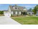 Attractive home showcasing a well-maintained lawn and a spacious driveway leading to a two-car garage at 143 Sallyport Ct, Raleigh, NC 27603