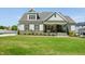 Charming craftsman home with stone accents, covered porch, and lush green lawn at 143 Sallyport Ct, Raleigh, NC 27603