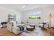 Relaxing living room featuring a comfortable sectional sofa, stylish decor, and natural light at 143 Sallyport Ct, Raleigh, NC 27603
