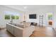 Inviting living room featuring natural wood flooring and a large window with scenic views at 143 Sallyport Ct, Raleigh, NC 27603