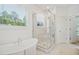 Bathroom featuring a soaking tub and a glass-enclosed marble shower at 143 Sallyport Ct, Raleigh, NC 27603