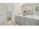 Bathroom with dual sinks, gray cabinets, and an enclosed glass and marble shower at 143 Sallyport Ct, Raleigh, NC 27603
