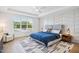 Bedroom featuring a large window, hardwood floors, and a tray ceiling at 143 Sallyport Ct, Raleigh, NC 27603