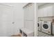 Mudroom with a built-in bench and storage, leading to a separate laundry room at 143 Sallyport Ct, Raleigh, NC 27603