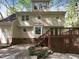 Backyard exterior featuring a deck and patio surrounded by lush greenery and mature trees at 145 Brannigan Pl, Cary, NC 27511