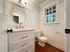 This half bathroom features board and batten, and a white cabinet sink at 145 Brannigan Pl, Cary, NC 27511