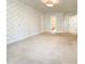 Bedroom featuring neutral carpet, wallpaper detail, and access to en-suite bathroom at 145 Brannigan Pl, Cary, NC 27511