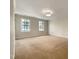 Bedroom with neutral carpet and wallpaper detail and natural light from two windows at 145 Brannigan Pl, Cary, NC 27511
