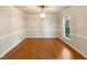Bright dining room with hardwood floors, classic trim and natural light from one large window at 145 Brannigan Pl, Cary, NC 27511