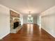 Bright living room with brick fireplace, hardwood floors, and modern light fixture at 145 Brannigan Pl, Cary, NC 27511