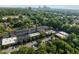 Aerial view of property with surrounding trees, a parking lot, and cityscape in the distance at 1535 Caraleigh Mills Ct # 104, Raleigh, NC 27603