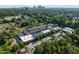 Wide aerial view of building with surrounding trees, parking, and cityscape in the background at 1535 Caraleigh Mills Ct # 104, Raleigh, NC 27603