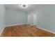 Spacious bedroom with hardwood floors, stylish lighting and a walk in closet at 1535 Caraleigh Mills Ct # 104, Raleigh, NC 27603