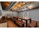 Common room features a large wooden table, exposed wooden beams, and a brick accent wall at 1535 Caraleigh Mills Ct # 104, Raleigh, NC 27603
