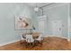 Elegant dining area featuring a round table, modern chandelier, and wood flooring at 1535 Caraleigh Mills Ct # 104, Raleigh, NC 27603