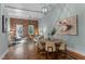 Open concept space showcasing the dining area with modern lighting and art at 1535 Caraleigh Mills Ct # 104, Raleigh, NC 27603