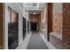 Hallway featuring brick walls, skylights, and black doors provide modern rustic charm and character at 1535 Caraleigh Mills Ct # 104, Raleigh, NC 27603