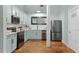 Bright kitchen with stainless steel appliances, light blue cabinets, and hardwood flooring at 1535 Caraleigh Mills Ct # 104, Raleigh, NC 27603