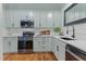 Well-lit kitchen with updated appliances, sleek countertops, and ample cabinet space at 1535 Caraleigh Mills Ct # 104, Raleigh, NC 27603