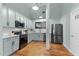 Modern kitchen featuring updated stainless steel appliances and hardwood flooring at 1535 Caraleigh Mills Ct # 104, Raleigh, NC 27603