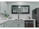Close up of kitchen with sleek countertops and modern stainless steel appliances at 1535 Caraleigh Mills Ct # 104, Raleigh, NC 27603