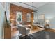 Inviting living room with exposed brick, stylish furniture, and an abundance of natural light at 1535 Caraleigh Mills Ct # 104, Raleigh, NC 27603