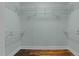 Spacious walk-in closet with ample shelving and wood floors at 1535 Caraleigh Mills Ct # 104, Raleigh, NC 27603