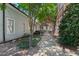 Green trees line a concrete walkway along the exterior of this multi-Gathering dwelling at 1535 Caraleigh Mills Ct # 104, Raleigh, NC 27603