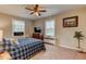 Cozy bedroom featuring a ceiling fan, windows, and a stylish blue-and-white patterned comforter at 1700 W Front St # 36 D, Burlington, NC 27215