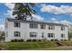 Exterior view of a white apartment building with grey shutters, landscaping, and lawn at 1700 W Front St # 36 D, Burlington, NC 27215