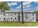 Rear view of a white brick apartment building with well-kept lawn and mature trees at 1700 W Front St # 36 D, Burlington, NC 27215