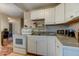 Functional kitchen with white cabinets, and standard appliances at 1700 W Front St # 36 D, Burlington, NC 27215