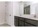 Double sink bathroom with quartz countertop, dark brown cabinets, and a view of the shower at 1817 Shady Oaks Dr, Wendell, NC 27591
