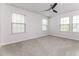 This bedroom has three windows that allows for natural light and has neutral walls and carpet at 1817 Shady Oaks Dr, Wendell, NC 27591