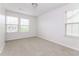 Bedroom featuring two windows, neutral walls, and plush carpeting for a cozy and inviting atmosphere at 1817 Shady Oaks Dr, Wendell, NC 27591