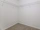 The closet has white walls and a wire rack for hanging clothes at 1817 Shady Oaks Dr, Wendell, NC 27591