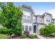 Inviting two-story townhome featuring lush landscaping and a well-maintained facade at 1817 Shady Oaks Dr, Wendell, NC 27591