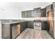Modern kitchen equipped with stainless steel appliances and dark cabinetry at 1817 Shady Oaks Dr, Wendell, NC 27591