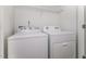 Functional laundry room features a washer and dryer, plus overhead wire shelving for storage and easy organization at 1817 Shady Oaks Dr, Wendell, NC 27591