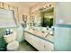 Bathroom featuring double sinks, blue tile, and an ample vanity mirror at 1829 Stewart Farm Rd, Henderson, NC 27537