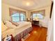 Bedroom featuring a full bed, hardwood floors, and large windows at 1829 Stewart Farm Rd, Henderson, NC 27537