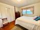 Bedroom with a four-poster bed, closet, and window with natural light at 1829 Stewart Farm Rd, Henderson, NC 27537