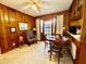 Cozy dining area with wood-paneled walls, a ceiling fan, and classic furnishings at 1829 Stewart Farm Rd, Henderson, NC 27537
