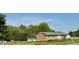 Quaint brick home with a well-maintained lawn and mature trees, creating a serene and inviting atmosphere at 1829 Stewart Farm Rd, Henderson, NC 27537