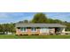 Charming brick ranch home with manicured lawn and attached carport providing functional curb appeal at 1829 Stewart Farm Rd, Henderson, NC 27537