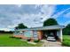 Charming brick ranch home with manicured lawn and attached carport providing functional curb appeal at 1829 Stewart Farm Rd, Henderson, NC 27537