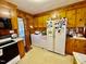Cozy kitchen featuring wooden cabinets, appliances, with a laundry area at 1829 Stewart Farm Rd, Henderson, NC 27537