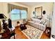 Cozy living room with a patterned sofa, floral rug, and natural light at 1829 Stewart Farm Rd, Henderson, NC 27537