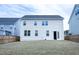 Rear exterior view of a two-story house with a wooden fenced-in backyard at 1950 Menet St, Apex, NC 27502